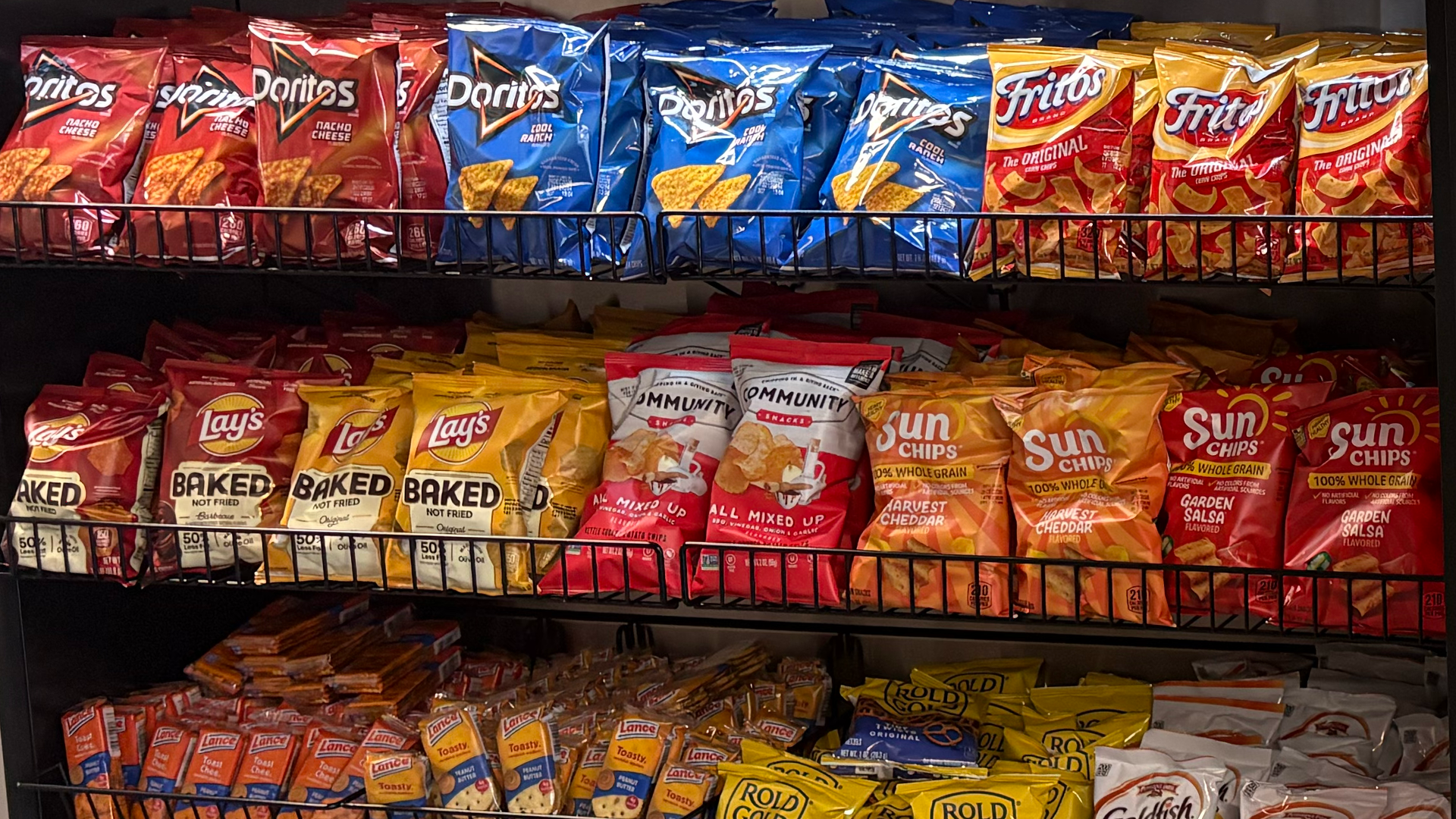 assorted chips and snacks on a display shelf
